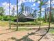 Home features a covered porch that wraps around the side, overlooking the landscape at 3805 Carder Ln, Cumming, GA 30028
