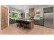Spacious kitchen featuring a large island with seating, stainless steel appliances, and modern cabinetry at 3805 Carder Ln, Cumming, GA 30028