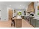 Bright kitchen featuring a large island with seating, stainless steel appliances, and modern cabinetry at 3805 Carder Ln, Cumming, GA 30028