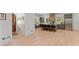 Open kitchen featuring an island with bar seating, a stainless steel refrigerator, and hardwood flooring at 3805 Carder Ln, Cumming, GA 30028
