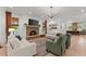 Open-concept living room featuring a stone fireplace, hardwood floors, and ample seating at 3805 Carder Ln, Cumming, GA 30028