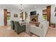 Bright living room with a stone fireplace, large windows, and comfortable seating arrangement at 3805 Carder Ln, Cumming, GA 30028