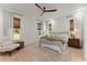 Bright main bedroom showcasing large windows, a ceiling fan, and neutral decor at 3805 Carder Ln, Cumming, GA 30028