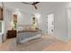 Bright main bedroom featuring large windows, a ceiling fan, and neutral decor at 3805 Carder Ln, Cumming, GA 30028