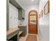 Well-organized mudroom with custom built-ins, bench seating, and a charming arched doorway at 3805 Carder Ln, Cumming, GA 30028
