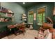 Cozy office with built-in shelving, a vintage desk, and two windows overlooking a serene landscape at 3805 Carder Ln, Cumming, GA 30028
