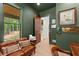 Comfortable olive-green office with a view to the outside and a comfortable leather couch at 3805 Carder Ln, Cumming, GA 30028