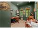 Stylish home office with olive-green walls, built-in bookshelves, and natural light at 3805 Carder Ln, Cumming, GA 30028