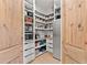 Spacious walk-in pantry with custom wood doors and shelving offering ample storage at 3805 Carder Ln, Cumming, GA 30028