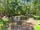 Scenic view of a tranquil pond surrounded by lush greenery and mature trees at 3805 Carder Ln, Cumming, GA 30028