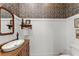 Stylish powder room featuring designer wallpaper, a vessel sink, and classic fixtures at 3805 Carder Ln, Cumming, GA 30028