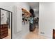 Open walk-in closet with custom shelving, wooden floor and lots of hanging storage at 3805 Carder Ln, Cumming, GA 30028
