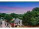 An aerial view of upscale homes nestled among lush greenery under a vibrant, colorful sky at twilight at 4550 Lois Se St, Smyrna, GA 30080