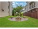 Relaxing backyard with a circular stone fire pit surrounded by a lush lawn and comfortable stone benches at 4550 Lois Se St, Smyrna, GA 30080
