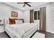 Comfortable bedroom with a ceiling fan, plush bed, decorative pillows, and dark hardwood floors at 4550 Lois Se St, Smyrna, GA 30080