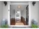 Elegant entryway featuring wood floors, a stylish mirror, and a glimpse of the staircase leading to the upper level at 4550 Lois Se St, Smyrna, GA 30080