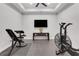 Well-lit exercise room featuring an exercise bike, weight bench, and mounted TV at 4550 Lois Se St, Smyrna, GA 30080