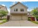 Home with a two car garage, neutral siding, and blue sky in the background at 4550 Lois Se St, Smyrna, GA 30080