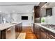 A kitchen with a stainless steel dishwasher and refrigerator faces the cooktop across wood floors at 4550 Lois Se St, Smyrna, GA 30080