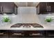 A modern cooktop with sleek backsplash is flanked by matching decor and cabinets at 4550 Lois Se St, Smyrna, GA 30080