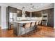 Gourmet kitchen boasts stainless steel appliances, an island with bar seating, and modern lighting at 4550 Lois Se St, Smyrna, GA 30080