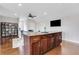 Living area with an island, built in bar, hardwood floors, and a view of the dining area at 4550 Lois Se St, Smyrna, GA 30080