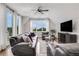Living room featuring comfortable seating, a ceiling fan, and large windows for natural light and a pleasant view at 4550 Lois Se St, Smyrna, GA 30080