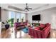 Stylish living room with tray ceilings, hardwood floors, and large windows offering plenty of natural light at 4550 Lois Se St, Smyrna, GA 30080
