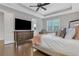 Inviting main bedroom with a large TV, decorative pillows, and a ceiling fan at 4550 Lois Se St, Smyrna, GA 30080