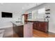 Kitchen with an island, a wet bar, stainless steel appliances, and floating shelves with a modern design at 4550 Lois Se St, Smyrna, GA 30080