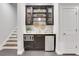 Wet bar area featuring a microwave, wine cooler, and glass front cabinets, perfect for entertaining near the stairs at 4550 Lois Se St, Smyrna, GA 30080