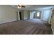 Carpeted bedroom featuring ample space, neutral colors, and multiple doors at 6231 Waterton Way, Lithonia, GA 30058