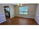 Dining room featuring hardwood floors, a window with natural light, and access to the kitchen at 6231 Waterton Way, Lithonia, GA 30058