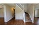 Inviting entryway with hardwood floors and a staircase with white railings at 6231 Waterton Way, Lithonia, GA 30058