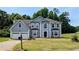 Charming two-story home featuring a two-car garage and a well-manicured lawn at 6231 Waterton Way, Lithonia, GA 30058