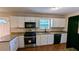 Modern kitchen featuring granite countertops, stainless steel appliances, and white cabinets at 6231 Waterton Way, Lithonia, GA 30058