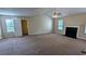 Large living room space with fireplace, windows and neutral carpet at 6231 Waterton Way, Lithonia, GA 30058