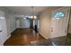 Spacious living room with hardwood floors, fireplace, and staircase access to the second story at 6231 Waterton Way, Lithonia, GA 30058