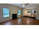 View of the living room with fireplace and hardwood floors, transitioning into the kitchen at 6231 Waterton Way, Lithonia, GA 30058