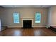 Bright living room showcasing a fireplace, windows, and hardwood flooring at 6231 Waterton Way, Lithonia, GA 30058