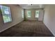 Large main bedroom with carpet, multiple windows and a tray ceiling at 6231 Waterton Way, Lithonia, GA 30058