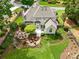 Beautiful backyard featuring a stone patio with a fire pit, an outdoor dining area, and mature trees at 725 Heathland Dr, Roswell, GA 30075