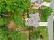 Expansive backyard featuring a stone patio with firepit, a dining area, mature trees, and immaculate landscaping at 725 Heathland Dr, Roswell, GA 30075