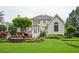 Lush backyard featuring a patio, landscaping, mature trees, and a well-maintained lawn at 725 Heathland Dr, Roswell, GA 30075