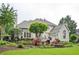 Expansive backyard with patio seating, lush landscaping, mature trees, and a well-maintained lawn at 725 Heathland Dr, Roswell, GA 30075