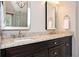 Bright bathroom featuring double sinks with granite countertops and dark cabinets at 725 Heathland Dr, Roswell, GA 30075