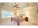 Spacious bedroom featuring a decorative ceiling fan and lots of natural light at 725 Heathland Dr, Roswell, GA 30075