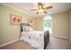 Comfortable bedroom with a floral patterned bedspread and a window with natural light at 725 Heathland Dr, Roswell, GA 30075