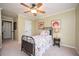 Cozy bedroom featuring floral bedspread and a window allowing natural light at 725 Heathland Dr, Roswell, GA 30075