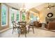 Breakfast room with a chandelier, a table with seating, and a view of the backyard at 725 Heathland Dr, Roswell, GA 30075